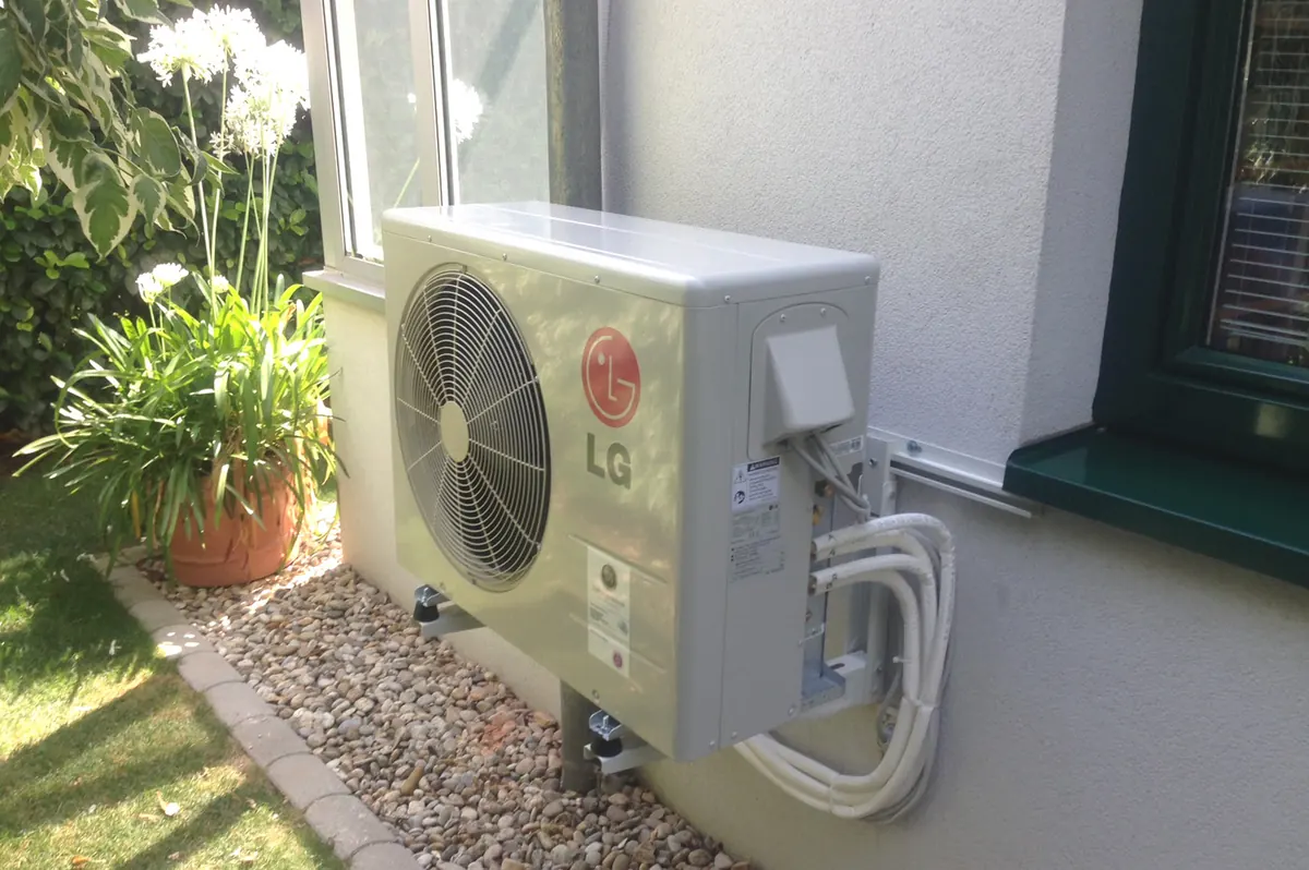 LG Außengerät auf Standfüßen im Garten eines Einfamilienhauses